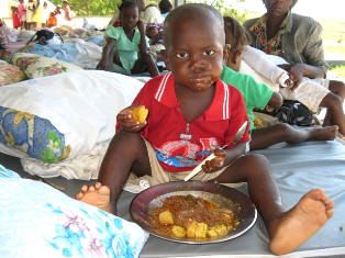 Young survivor enjoys a meal