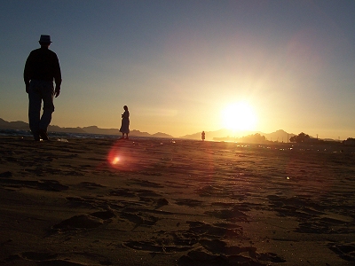 Three people at Cochorit Beach at sunset: Mark Roth, Ruby Roth, Chris Strubhar