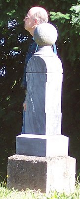 behind gravestone